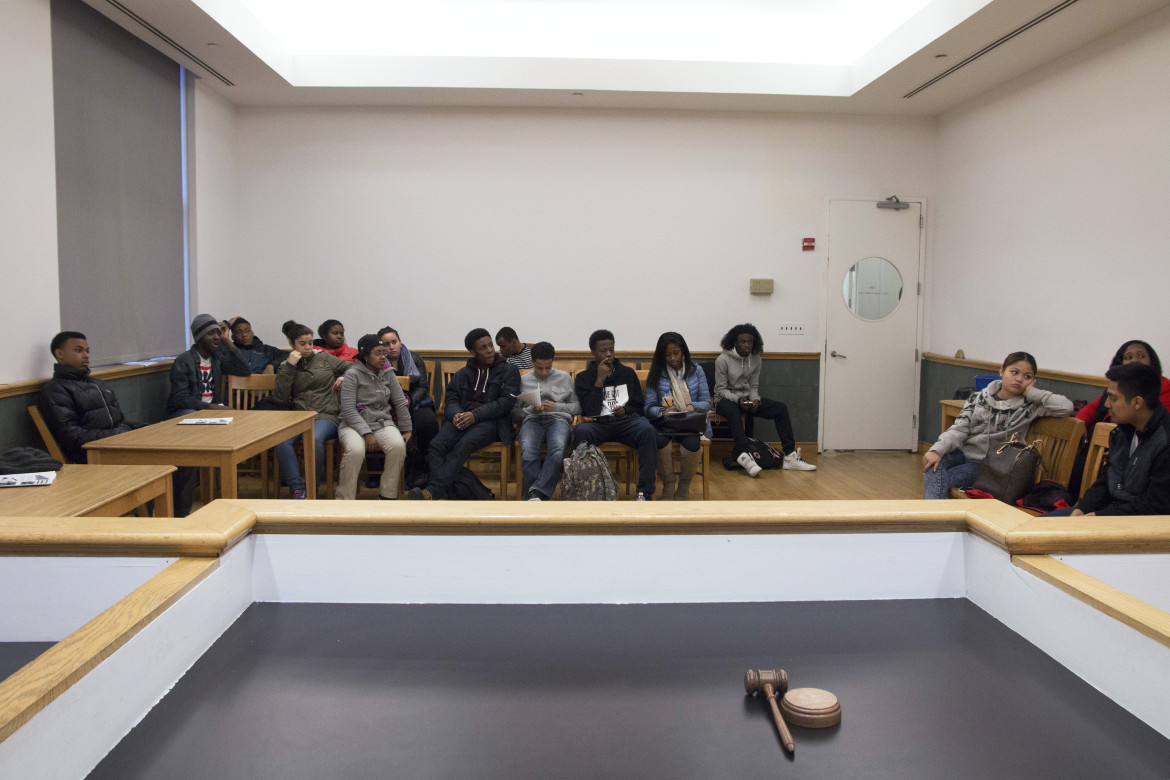 Teens and coordinators of the Red Hook Youth Court confer after two cases of truancy in 2015.